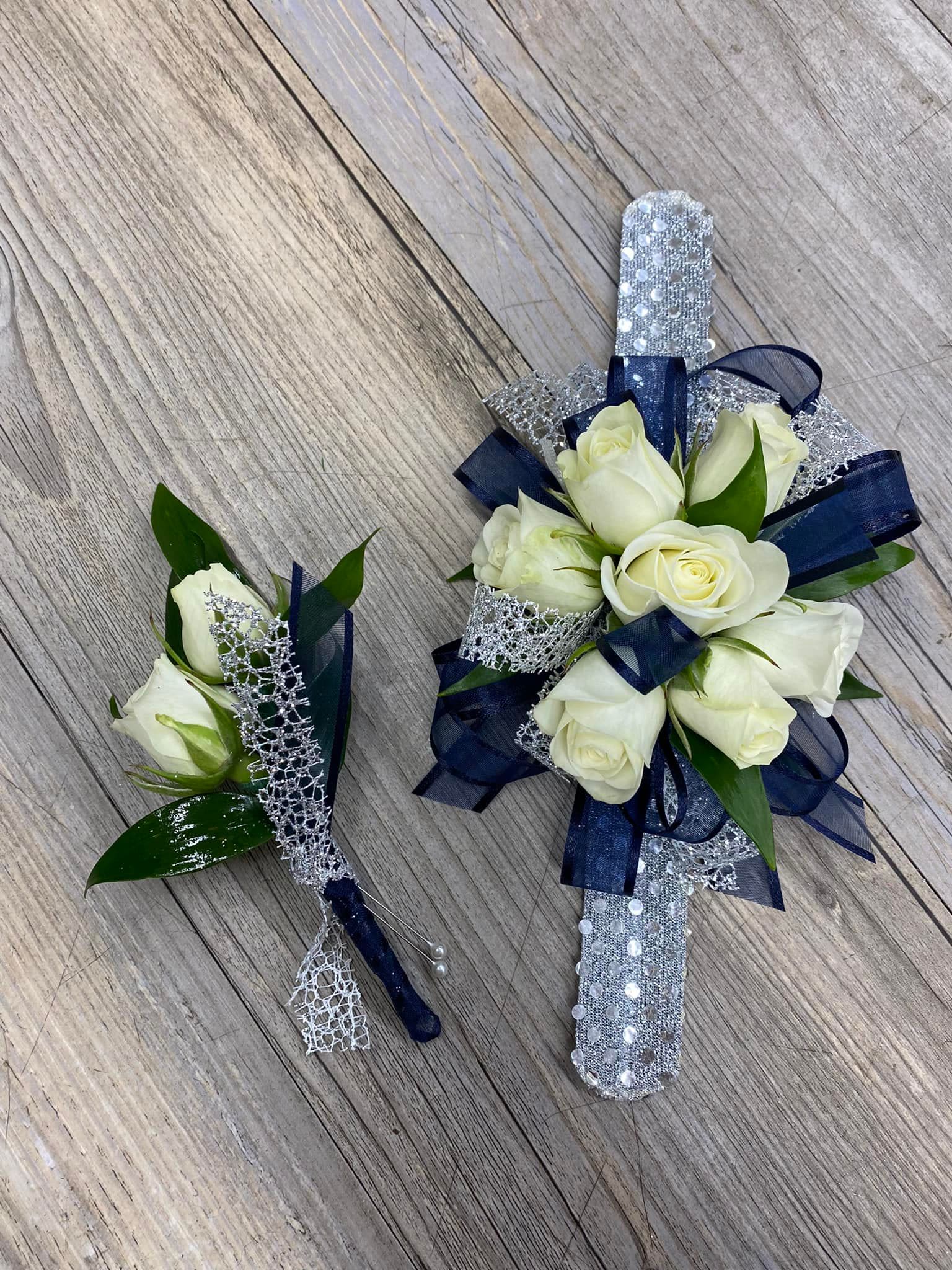 Navy Duo - This wristlet and boutonniere combo features white spray roses with navy and silver glitter ribbon.