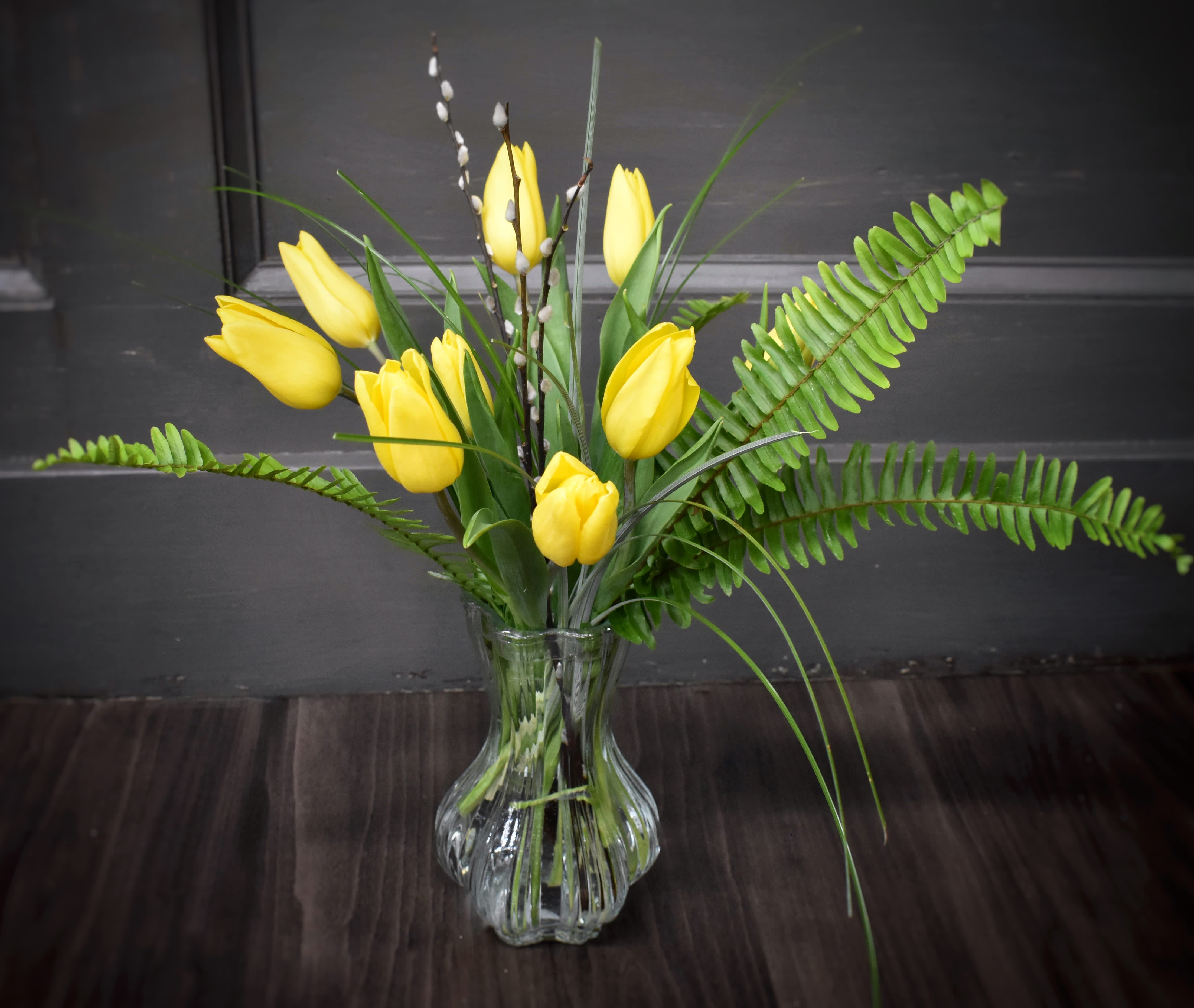Vintage Tulips - We LOVE this vintage glass vase that showcases the tulips and simple foliages used to accent them. ****** color of tulips may be different than the picture depending on stock on hand.  Deluxe- 5 more tulips will be added