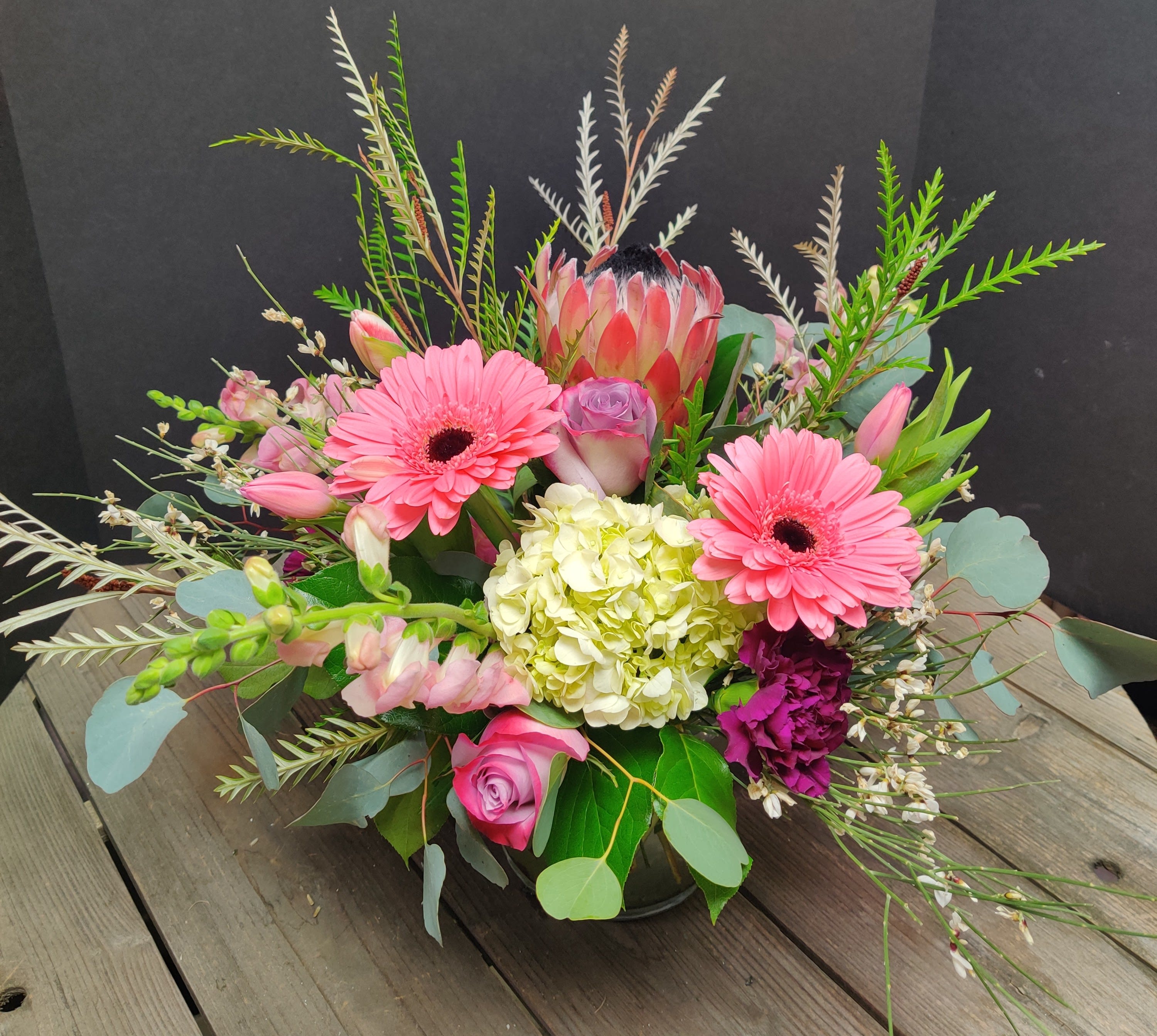 Enduring Love - Protea is the center of this beautiful centerpiece full of blooms 