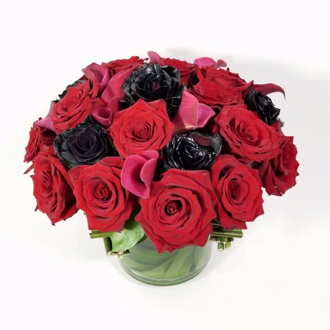Melisandre  - Modern Elegant Floral Arrangement  of Fresh Cut Red Roses, Black Roses, Burgundy Mini Callas, and Hand Made Bundles of Rose Stands to Complement the Unique Design.  