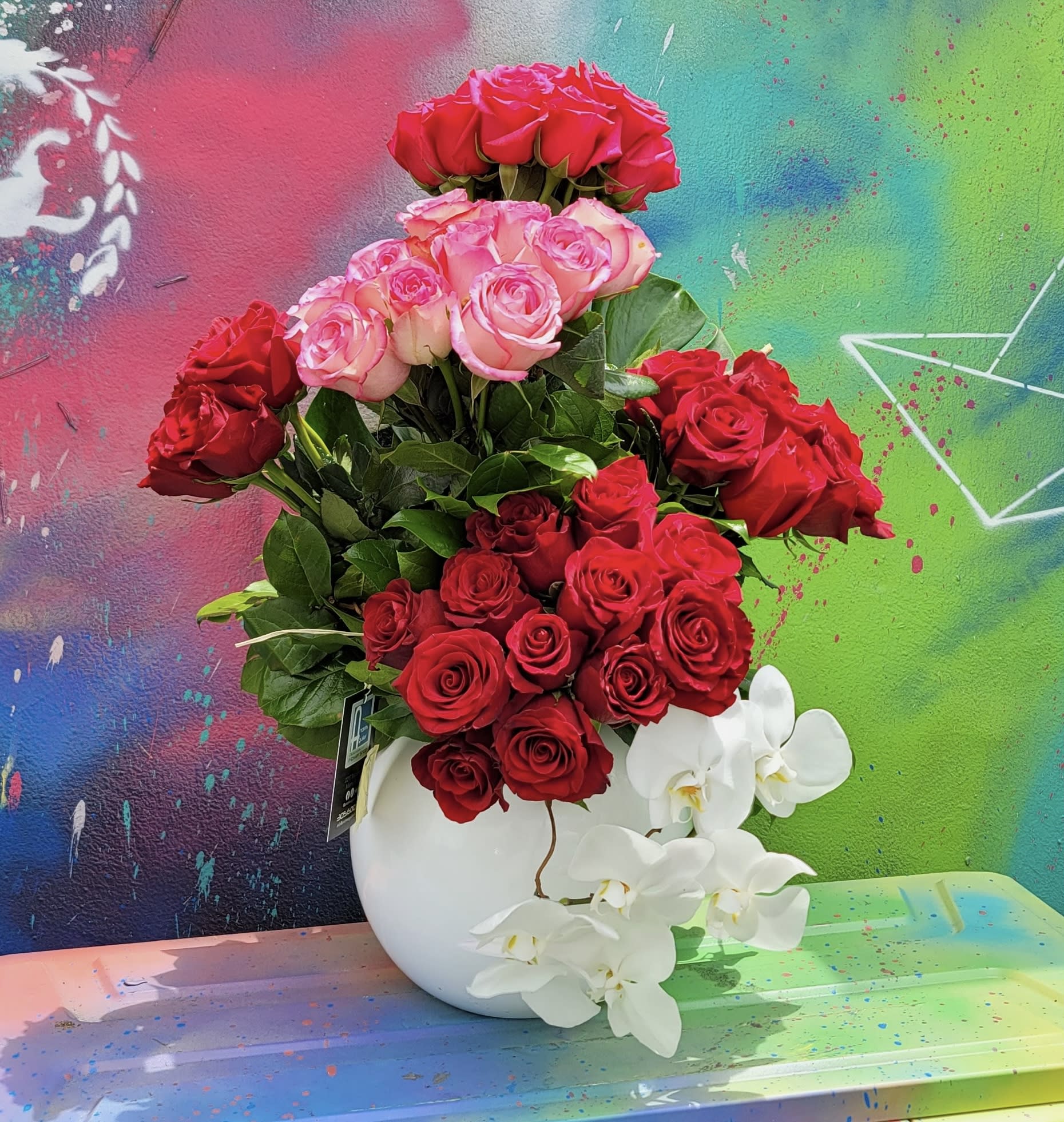 Bunch of Love - White bubble vase whit roses and greens.