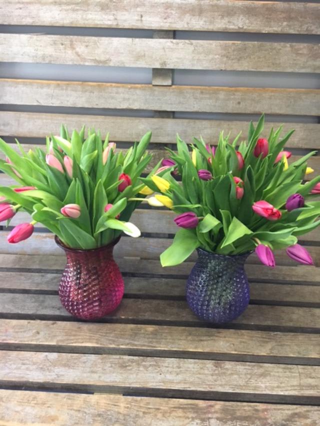 Assorted spring  tulips - Assorted color tulips in a colored glass vase. Designer' choice of colors