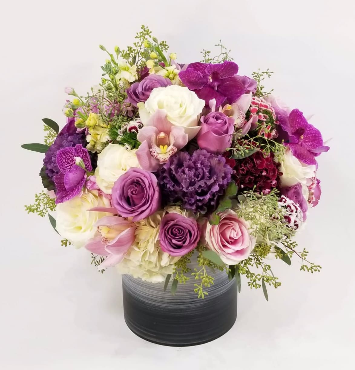 Secret purple garden - Beautiful French Style Arrangement in a ceramic vase with White Roses, Lavender Roses, Purple Kale, Pink Stock, Cream Stock, Purple Vanda Orchids, Pink Phaleanopsis orchids, Pink Cymbidium Orchids, Seeded Eucalyptus, Hydrangeas, and Dianthus.   Approximately 15" H by 15" W