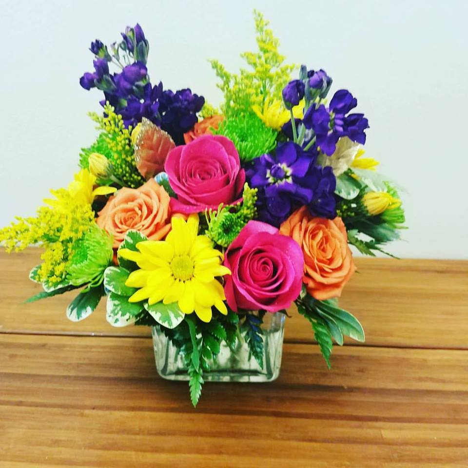 Bright cube Arrangement  by the Purple Orchid  - Bright and colorful mix of fresh flowers. Great to brighten any ones day. Mix of Roses, Daisies, Stock and Mums *** all Cube arrangement are short compact arrangements ****