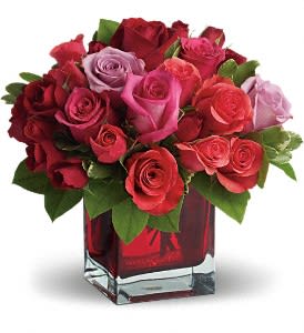  Madly in Love Bouquet with Red Roses [T9-3A] - If you're crazy about someone and not afraid to show it, this bright jewel-toned arrangement is the perfect way to express your love.  Lavender, red and hot pink roses along with coral and red spray roses arranged in a red-hot cube vase are an absolutely beautiful way to get your message across.  Approximately 11" W x 10" H  Orientation: All-Around      As Shown : T9-3A  THIS ITEM WILL NOT BE AVAILABLE AT THIS PRICE FOR DELIVERY FEB 10-15.  ALL AVAILABLE ARRANGEMENTS FOR THESE DAYS CAN BE FOUND IN THE VALENTINE’S 2020 MENU.