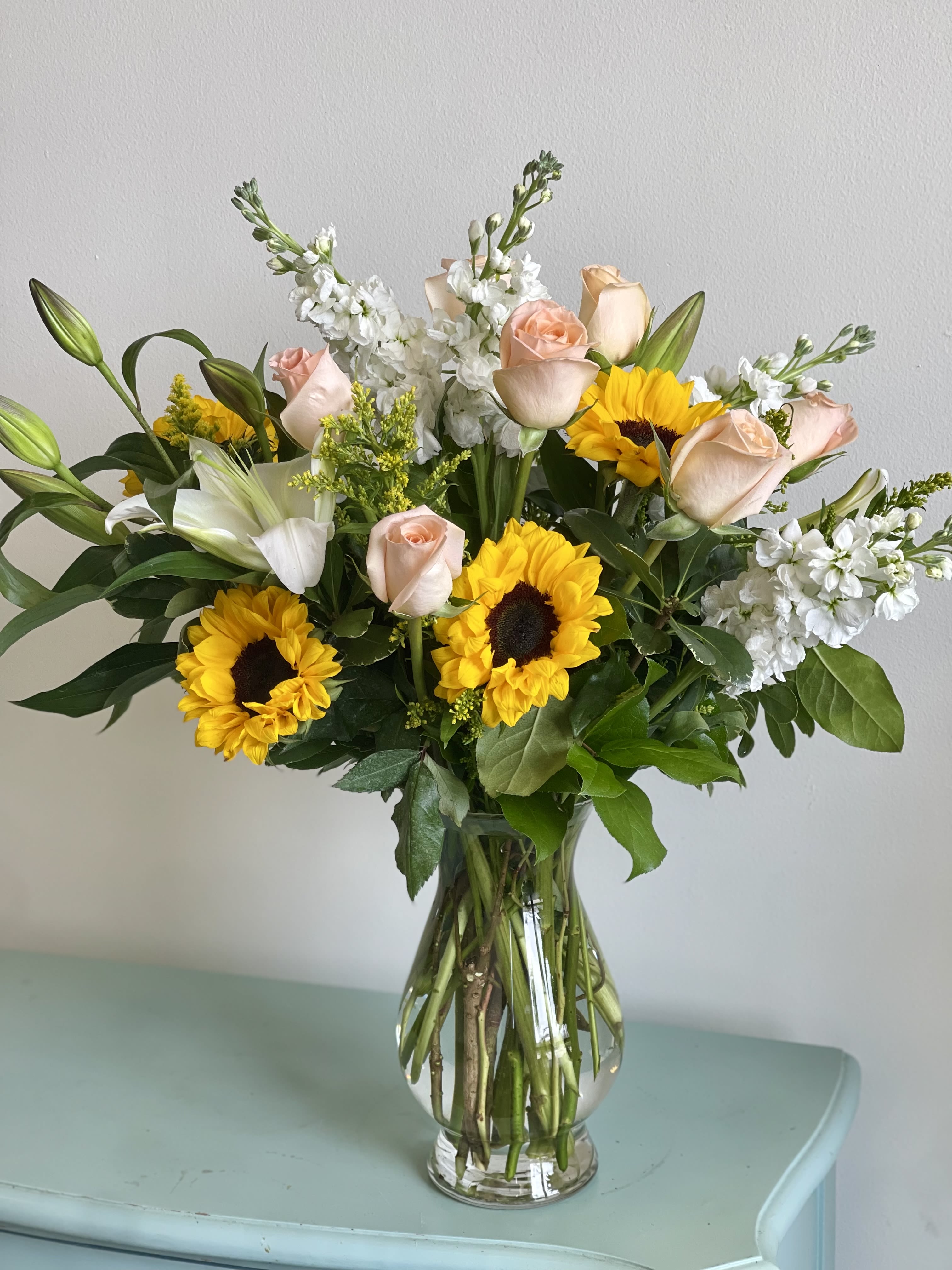 Just Peachy  - A beautiful arrangement of peach shimmer roses, sunflowers and stock! 