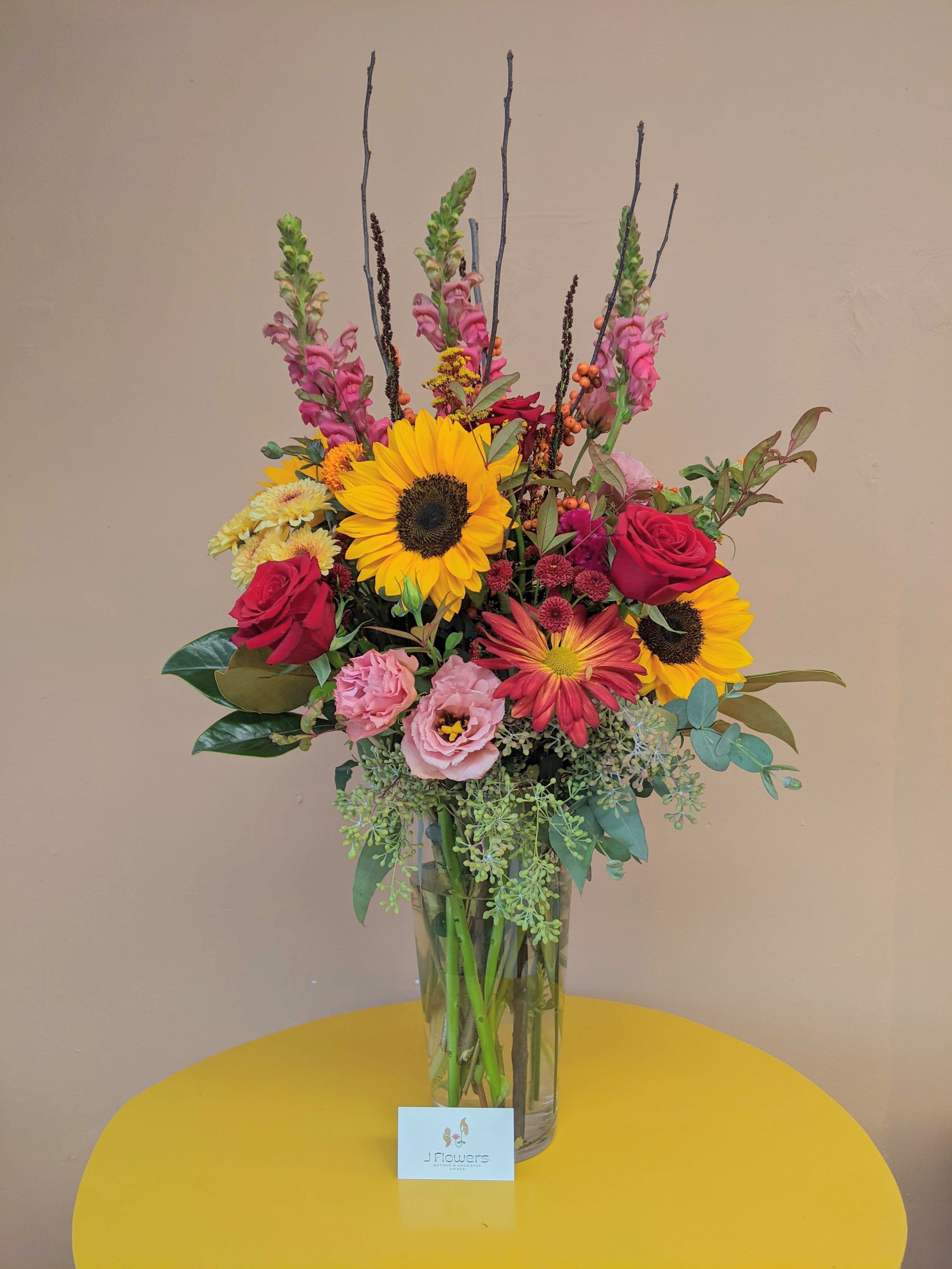 Bright Autumn - Some pinks mixed in with your classic fall tones arranged in a tall and full style is perfect for a gift to your hostess with the mostest! Due to the flower shortage, substitutions for floral selections may be made but we will always try to keep a similar look and feel to the overall arrangement.