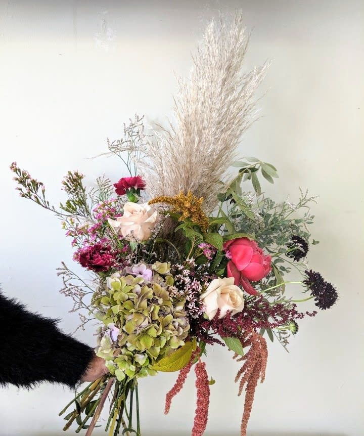 Boho Bouquet - A hand tied bouquet of all the boho goodness! An array of wild fillers and greenery paired with some big blooms will wow anyone! Note: this arrangement is a hand tied bouquet and does not include a vase. 