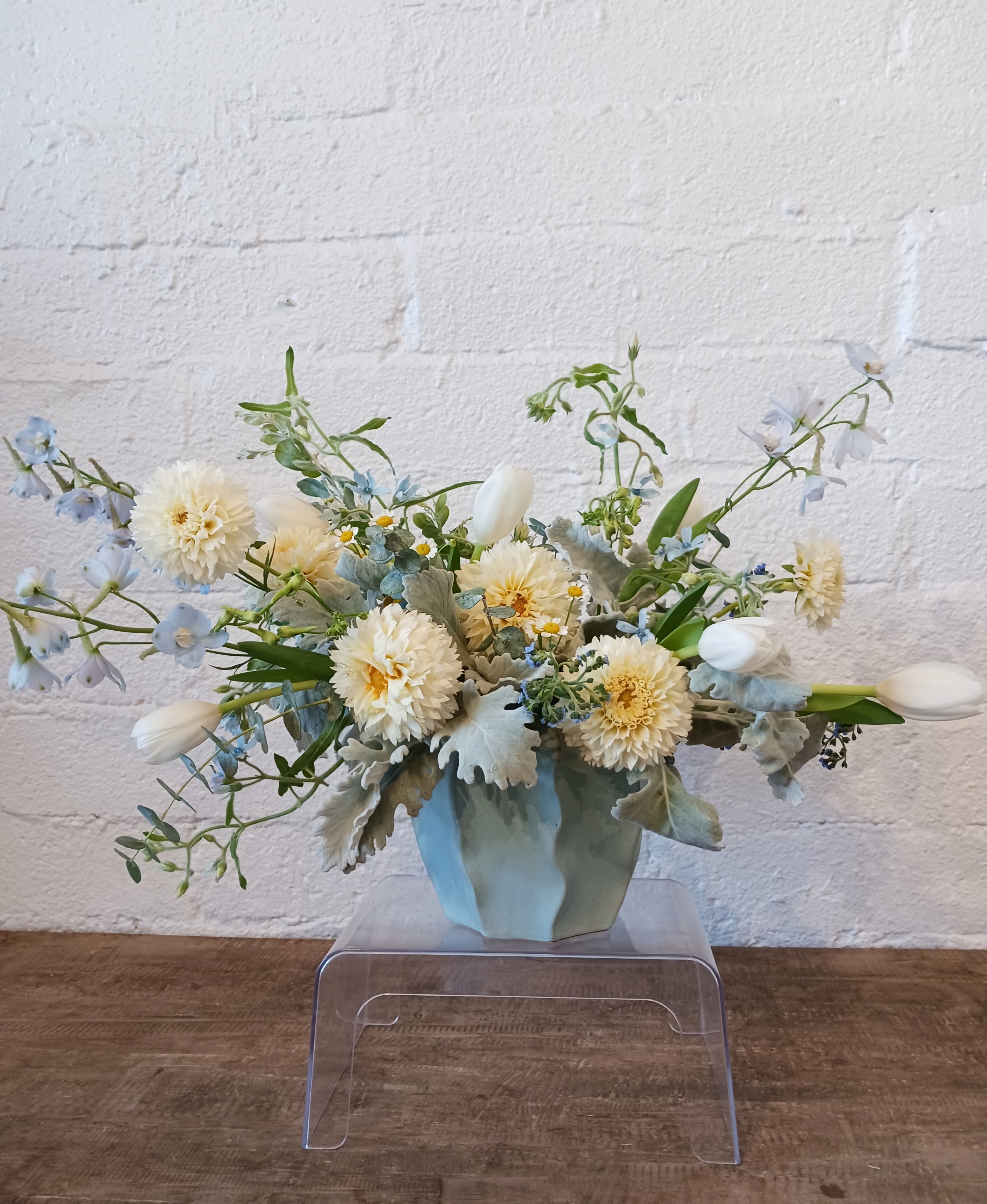 Sunshine Coast [OUT OF STOCK] - A beautiful arrangement full of dahlias and tulips arranged in a blue ceramic vase.  DISCLAIMER: We are currently out of the vase for the standard that is shown in the picture. Only Upgrades will be available. Final product will be fuller than what's shown in the picture.  