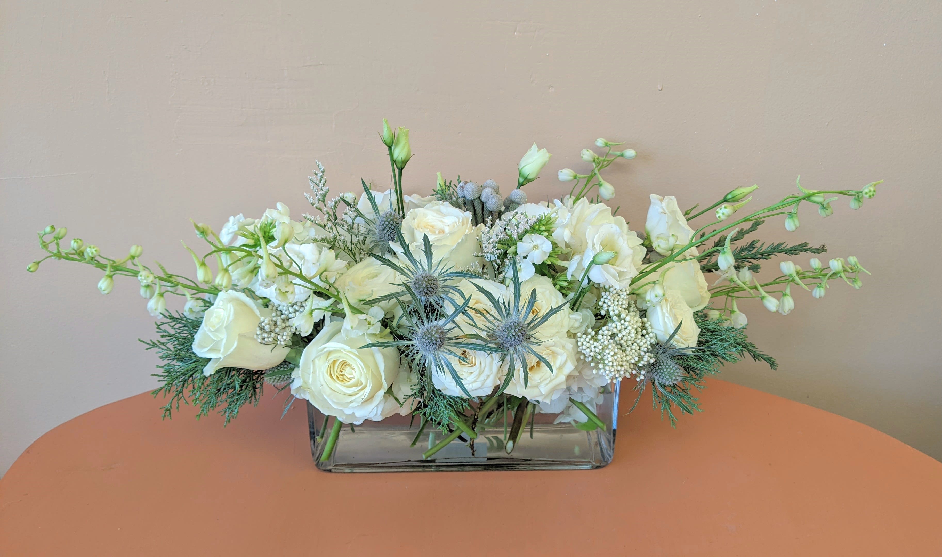 Sea Holly  - Long and low centerpiece in a clear rectangular vase. Perfect for any holiday party! 