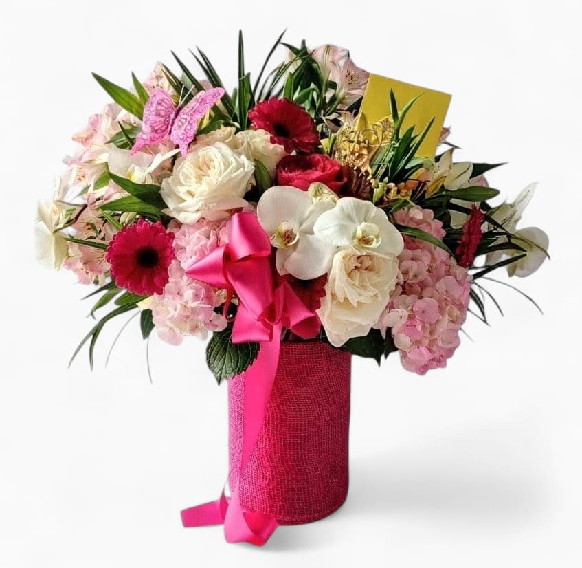 Pink Dazzler Bouquet Designer's Choice - Beautiful bouquet filled with roses hydrangeas and orchids arranged in a tall modern glass vase wrapped in hot pink jute ribbon. Perfect to send today to make them smile.