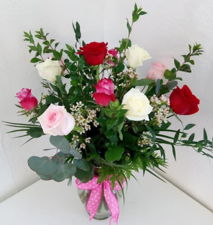 One Dozen Assorted Roses - One dozen assorted color roses arranged in a vase with greenery.