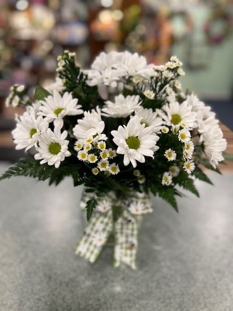 Crazy for Daisies (CFD) - The simplicity of fresh white daisies gathered into a clear glass vase with aster and finished with a green and white checked bow.