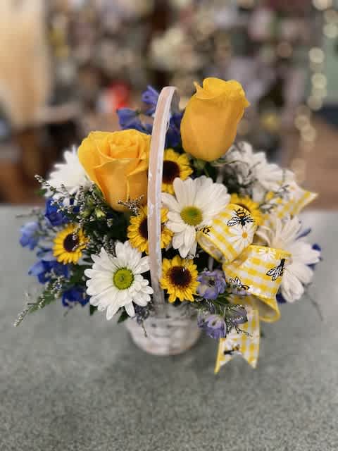 Thinking of you Basket (TOYB) - A nice way to tell someone you are thinking of them. A small basket filled with deliphium, yellow roses and oither assorted flowers.