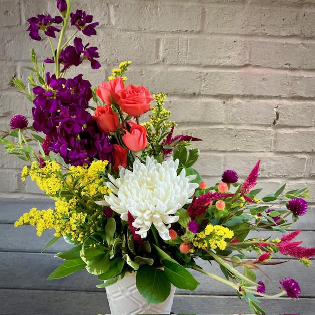 Brilliant Blossoms  - "Brilliant Blossoms" is a beautiful and petite floral design of vibrant flowers such as Chrysanthemums, Stock, Gomphrena, and an assortment of fillers to create a stunning and distinctive floral gift. Including colors of purple, orange , white and yellow, this lovely bouquet is sure to brighten any home or office space.