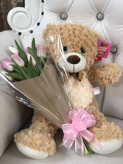 Cuddly Tulips - pink and white tulips wrapped in plastic paired with a cuddly teddy bear