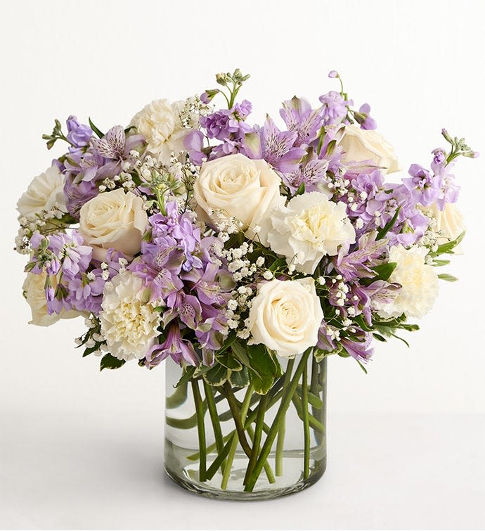 Lovely Lavender - Lovely memories are made with thoughtful gifts for the ones we care about. Our charming lavender flower bouquet is loosely gathered with a medley of lavender &amp; white blooms. Hand-designed inside a clear cylinder vase with cascading greenery all around, it’s a wonderful way to express the sentiments you have inside your heart.