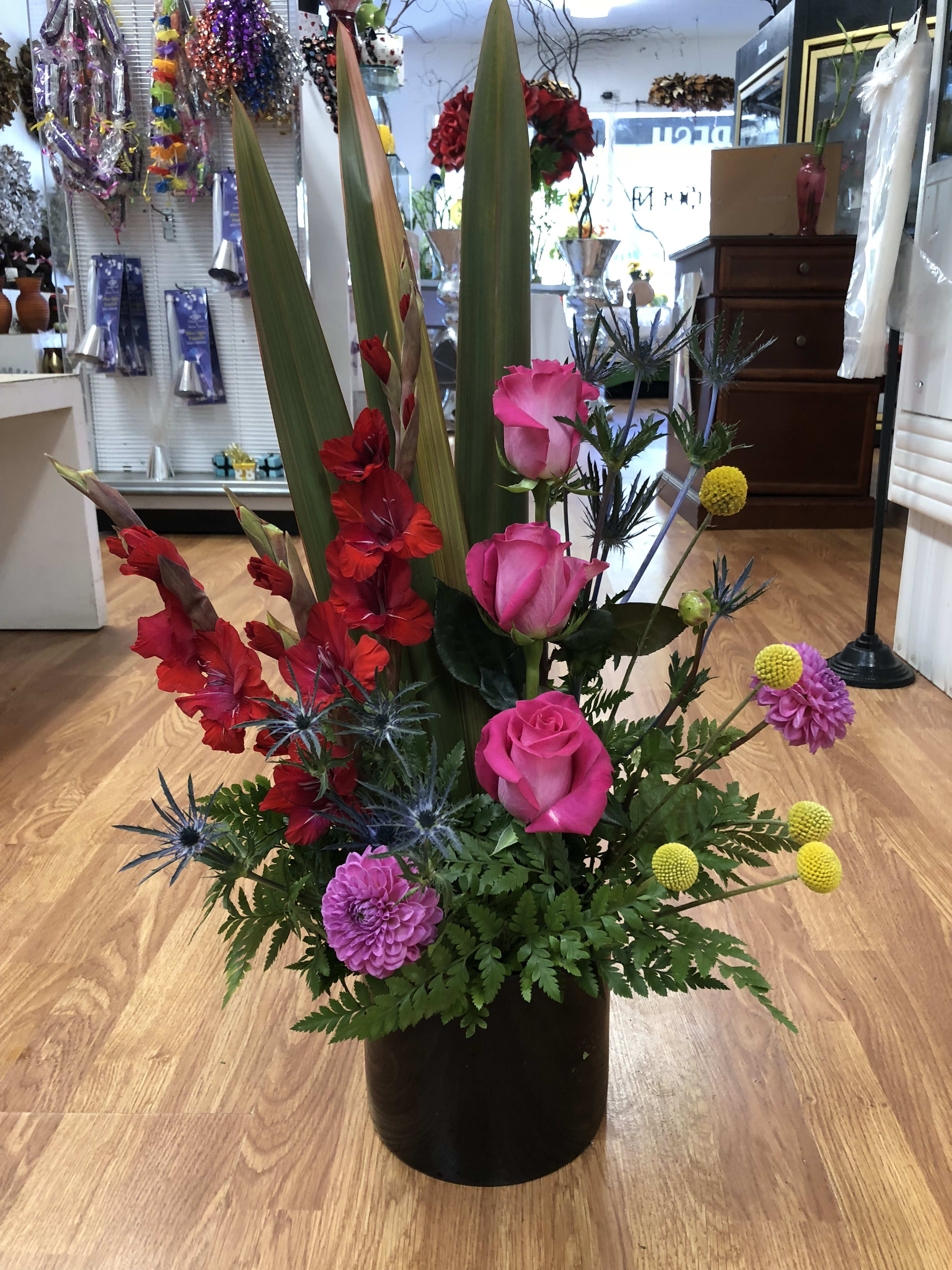 Red purple and yellow  - Red gladioli hot pink roses lavander carnation and exotic plants