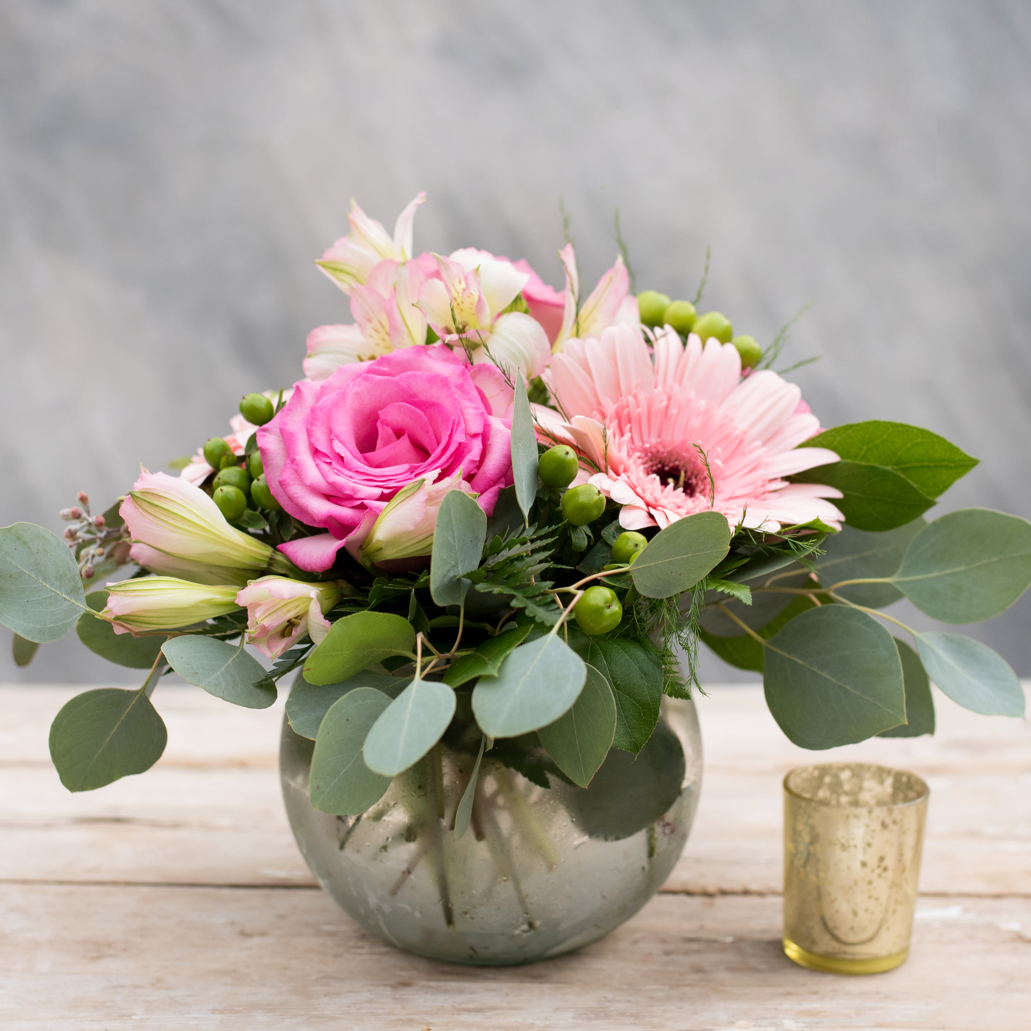 Kendal - A perky pink arrangement in a 5" bubble bowl including gerbera daisies, roses, alstroemeria with premium greens.  