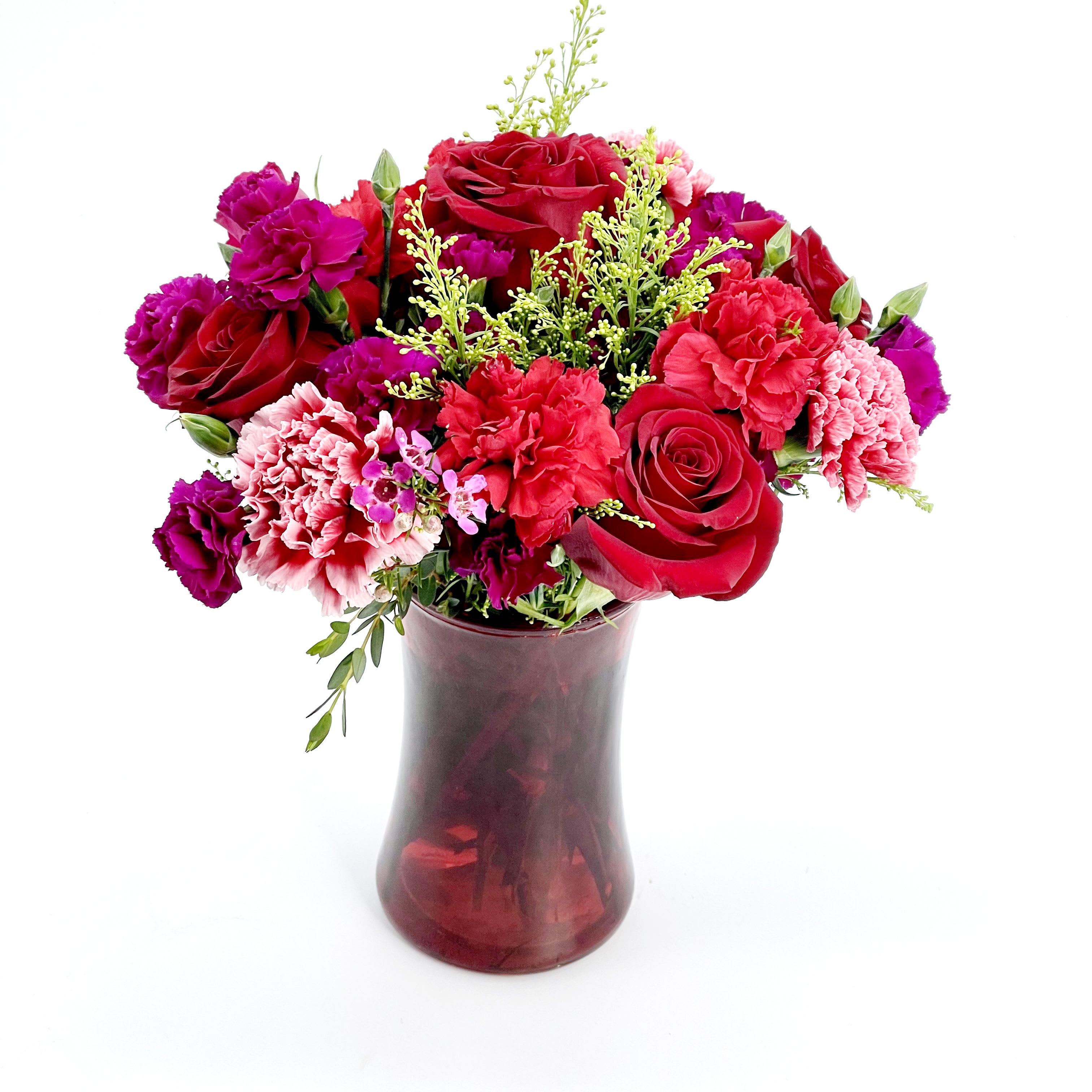 Lovely Red Bouquet - An Arrangement of Red and Hot pink Roses, Carnations, and greenery in a red glass vase.