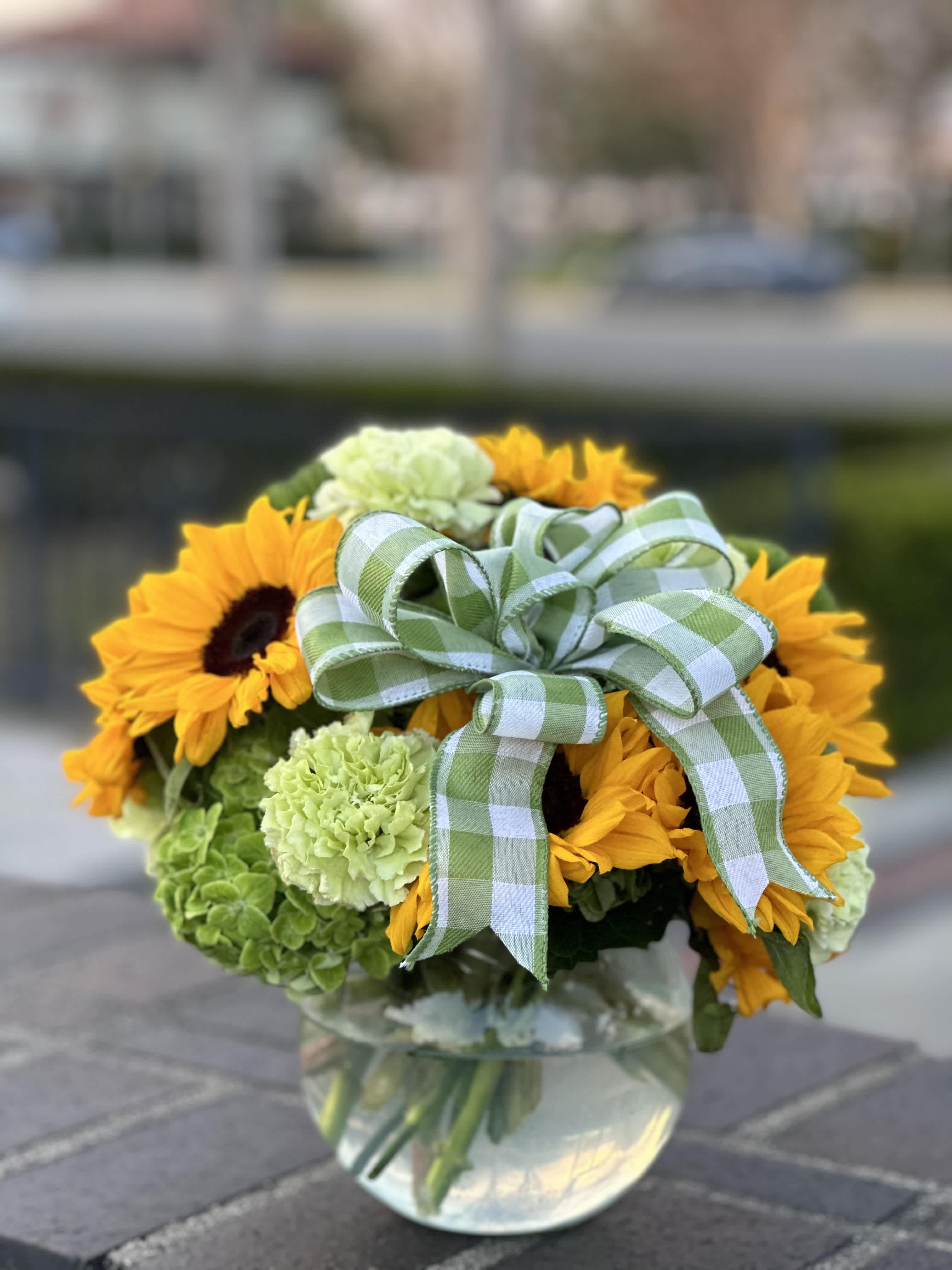 St. Patrick day - Embrace the luck of the Irish with our St. Patrick's Day floral creation!  Our vibrant arrangement features lush green hydrangeas, cheerful green carnations, delicate green dianthus, and sunny yellow sunflowers, bringing a burst of springtime joy to your celebrations!