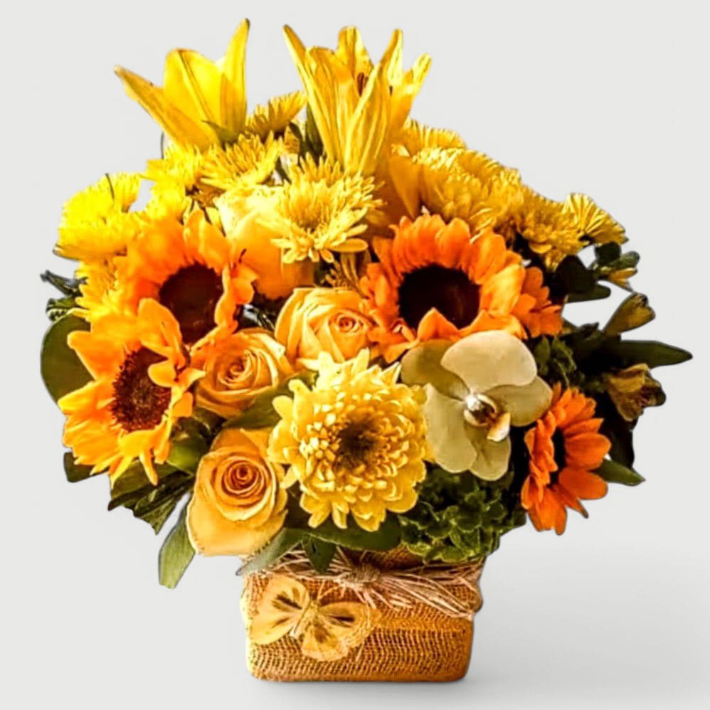 Thinking Of You Designer's Choice - Roses and more arranged in a modern glass cube style vase wrapped in pretty yellow jute ribbon. Always made extra special and unique each time. Perfect to send for a condolences. Send them your deepest condolences.