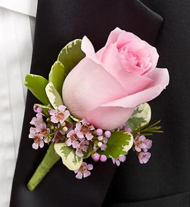 Pink Boutonniere - A charming pink rose, pink waxflower and variegated pittosporum creates an elegant boutonniere for the groom, ushers, fathers, grandfathers, or treasured relatives.  Hand-crafted boutonniere features pink roses and pink waxflower, accented with variegated pittosporum 