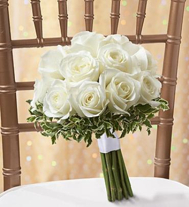 White Rose Bouquet - We’ve captured all the joy and happiness of new beginnings into one blissful bouquet! Filled with a fresh gathering of crisp white roses, our florists take extra special care, hand designing each arrangement to make every bride smile on her special day. Tied with matching satin ribbon and available in three sizes for each member of the bridal party. 