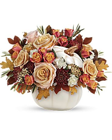  Harvest Charm Bouquet - Elegant crème roses blend with the heartwarming hues of autumn in this charming bouquet, artfully arranged in a white-lidded pumpkin bowl, a versatile fall decor favorite! This charming arrangement features crème roses, white miniature carnations, burgundy cushion spray chrysanthemums, yellow cottage yarrow, olive, and brown copper beech. Delivered in an Enchanted Harvest Pumpkin. Orientation: All-Around