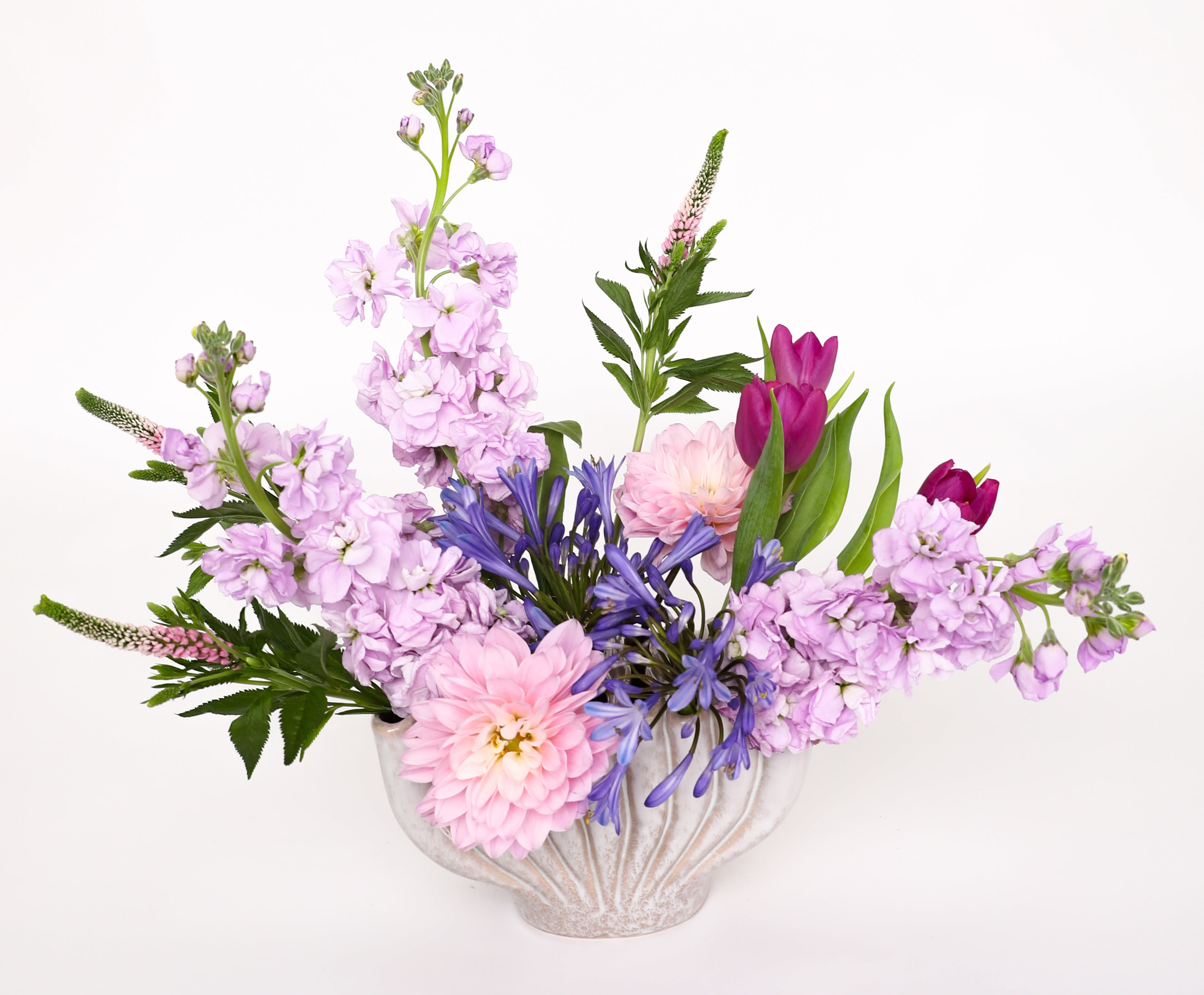 Simple Sentiment - We love this vase. We took a photograph of it all by itself so you could see how and why we love it so much. You can actually see down inside the vase with this cool design.You can't see it in the photograph, but this is what makes this so special. We used stock, dahlia's, agapanthus, veronica, and tulips. 