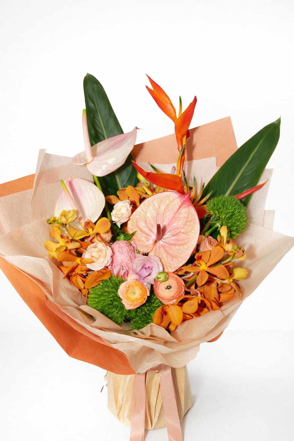 Golden Mirage - A tropical statement bouquet in rich shades of peach, blush, orange, and lime.   Featuring bold sculptural forms, glossy textures, and dynamic movement, this piece is designed to turn heads.
