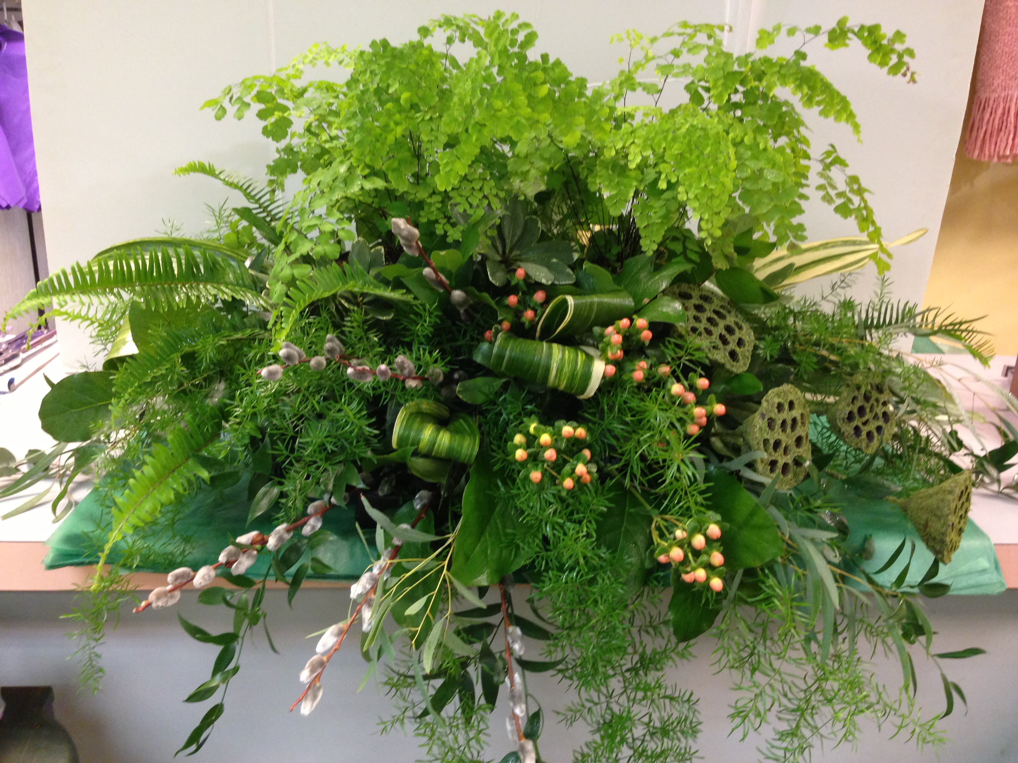 NON-FLORAL GREEN CASKET COVER - Maiden Hair Fern , Lotus Pods (Moss covered) , Hypericum , Pussy-Willow , Eucalyptus and Assorted Greens.