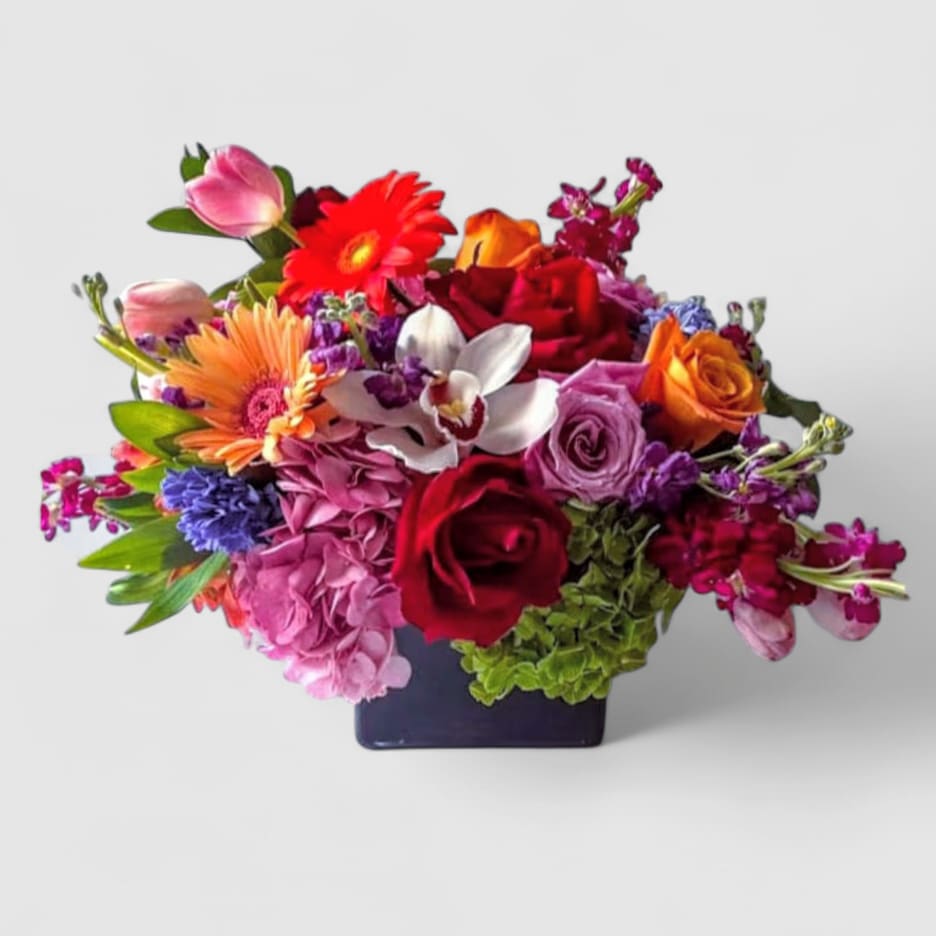 Celebration Of You Designer's Choice - Roses orchids hydrangeas and so much more arranged in a modern black glass cube vase. Beautiful and perfect to send to show them how much you care. Always made unique and extra special each and every time. Send them happiness.