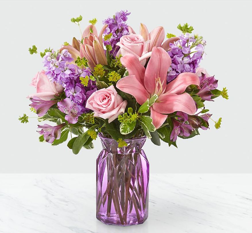 Full of Joy - There's something about an alluring mix of pink and purple florals that put a spring in our step! Fresh lilies, roses and stock add an array of beautiful texture in our Full of Joy ™ Bouquet. Its bursting hues and bright blooms are perfect to celebrate this season. PLEASE NOTE VASE NOT AVAILABLE. 