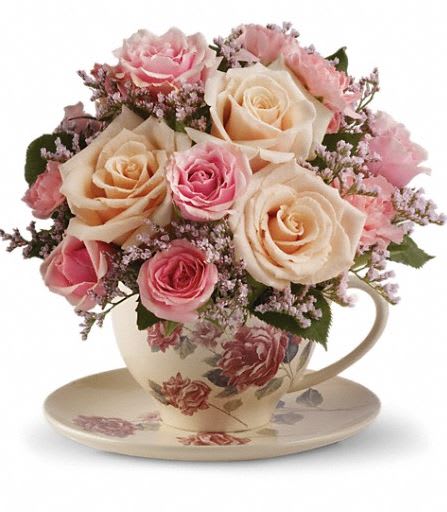T210-3A Teleflora's Victorian Teacup Bouquet - Send warm wishes with this lovely gift bouquet that arrives in a ceramic teacup. This charming, old-fashioned bouquet features pink and crème roses. Cream roses, pink spray roses, miniature pink carnations and delicate pink limonium are presented in a teacup and saucer with a Victorian flower pattern. Approximately 7 3/4" W x 7 1/2" H 
