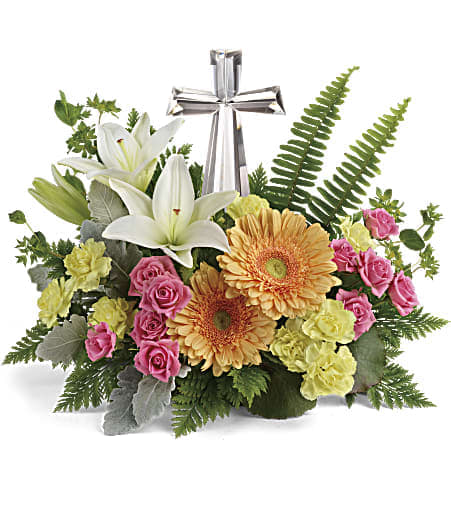 Teleflora's Precious Petals Bouquet - Nestled among bright orange gerberas, pink roses and white lilies, this precious crystal cross keepsake brings joyful reverence to your special occasion. Pink spray roses, white asiatic lilies, light orange gerberas, and yellow miniature carnations are accented with bupleurum, dusty miller, galax leaves, sword fern, and leatherleaf fern. Delivered with a Crystal Cross keepsake.  