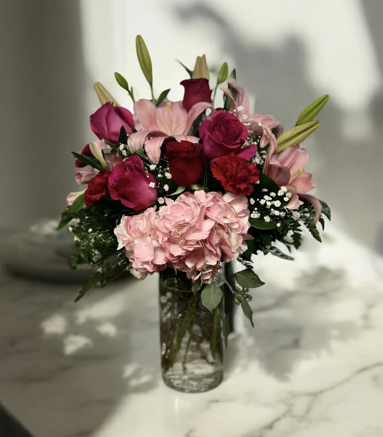 Eternal Embrace Design - Roses, lilies, carnations and a hydrangea designed in a cracked glass vase.
