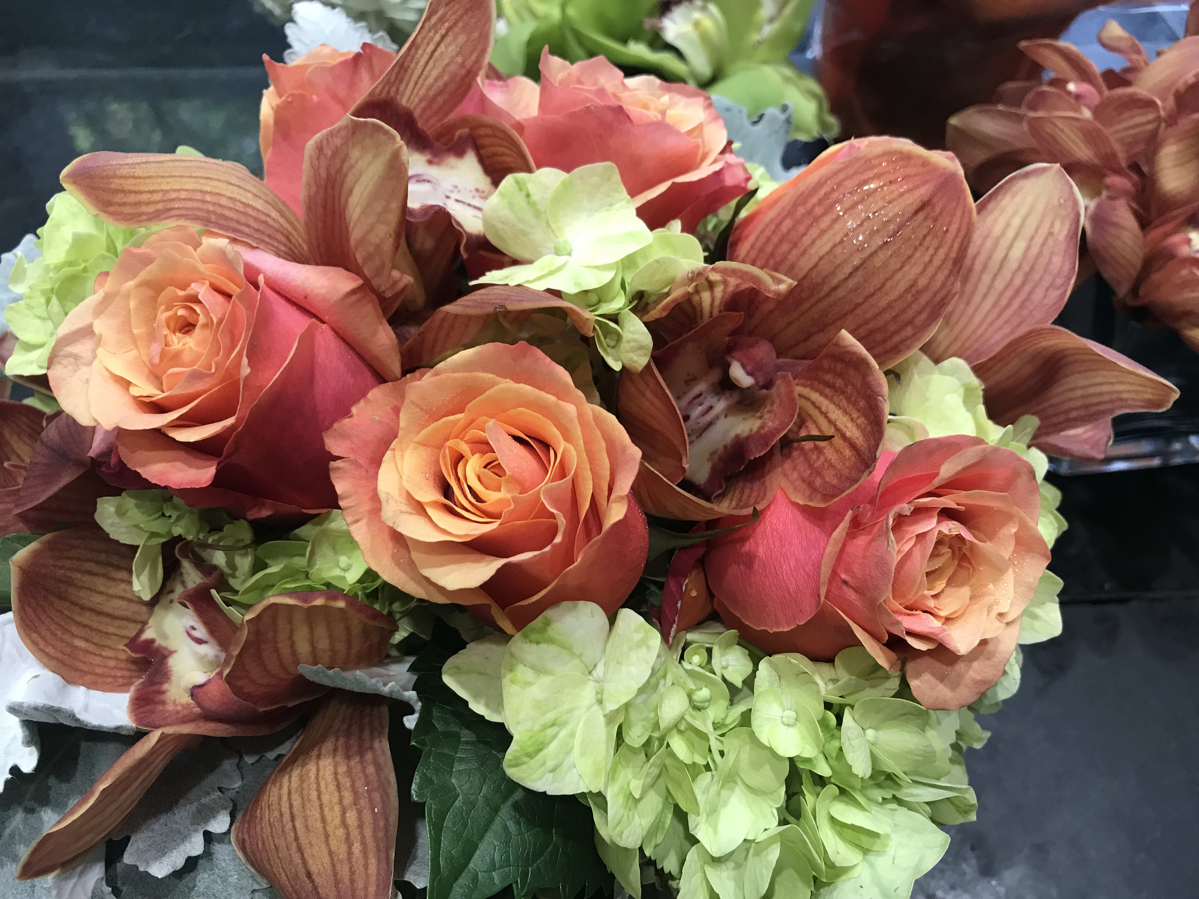 Chiltern Hills Beauty - Green hydrangea , orange roses, cymbidium orchids in square or cylinder 