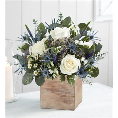Twilight Skies Bouquet -  Celebrating the beauty of the twilight sky, our latest arrangement is designed to inspire. Created by Rita Hoagland from Sieffert’s Flower Mill in North Canton, this loose gathering has all the beauty of a field of wildflowers. Its subtle shades provide the perfect complement to our rustic, grey-washed wooden cube making it a gift that twinkles with charm. All-around arrangement with purple Veronica, white roses, monte casino and statice, blue thistle, purple trachelium; accented with spiral eucalyptus and assorted greenery Artistically designed in our exclusive grey washed wooden cube with rustic style and natural,