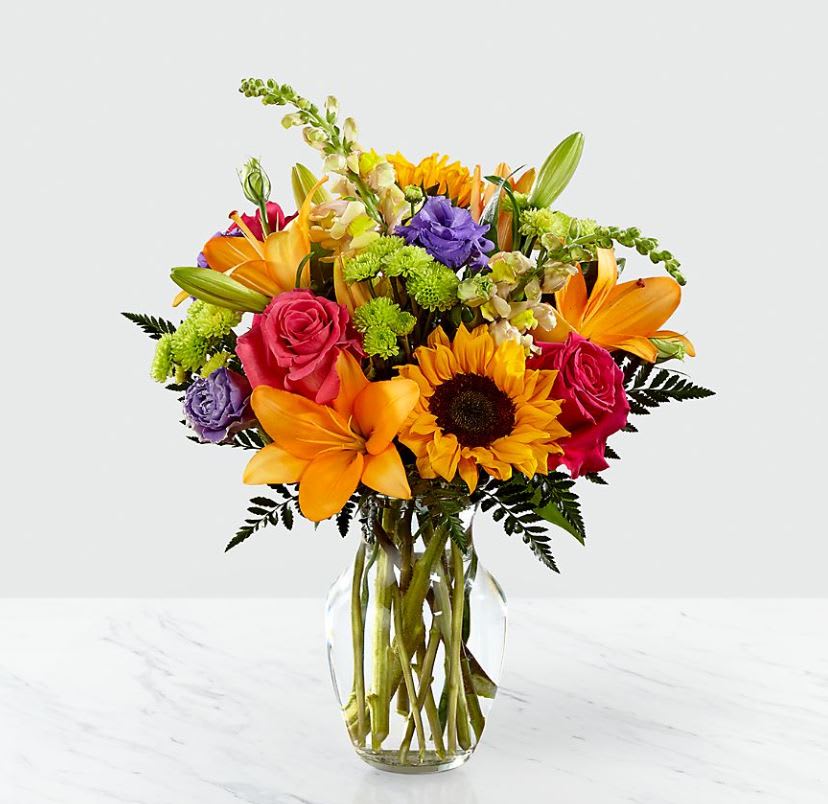 Best Day Bouquet - The Best Day ™ Bouquet is ready to create a moment your recipient will always remember! This instant mood booster is the perfect combination of bright, bold colors and gorgeous florals. A mix of roses, lilies, snapdragons and button pompons makes this day, their best day. Handcrafted in a clear glass vase, this fresh flower arrangement is made just for you to help you send your warmest birthday or get well wishes to your favorite friends and family.
