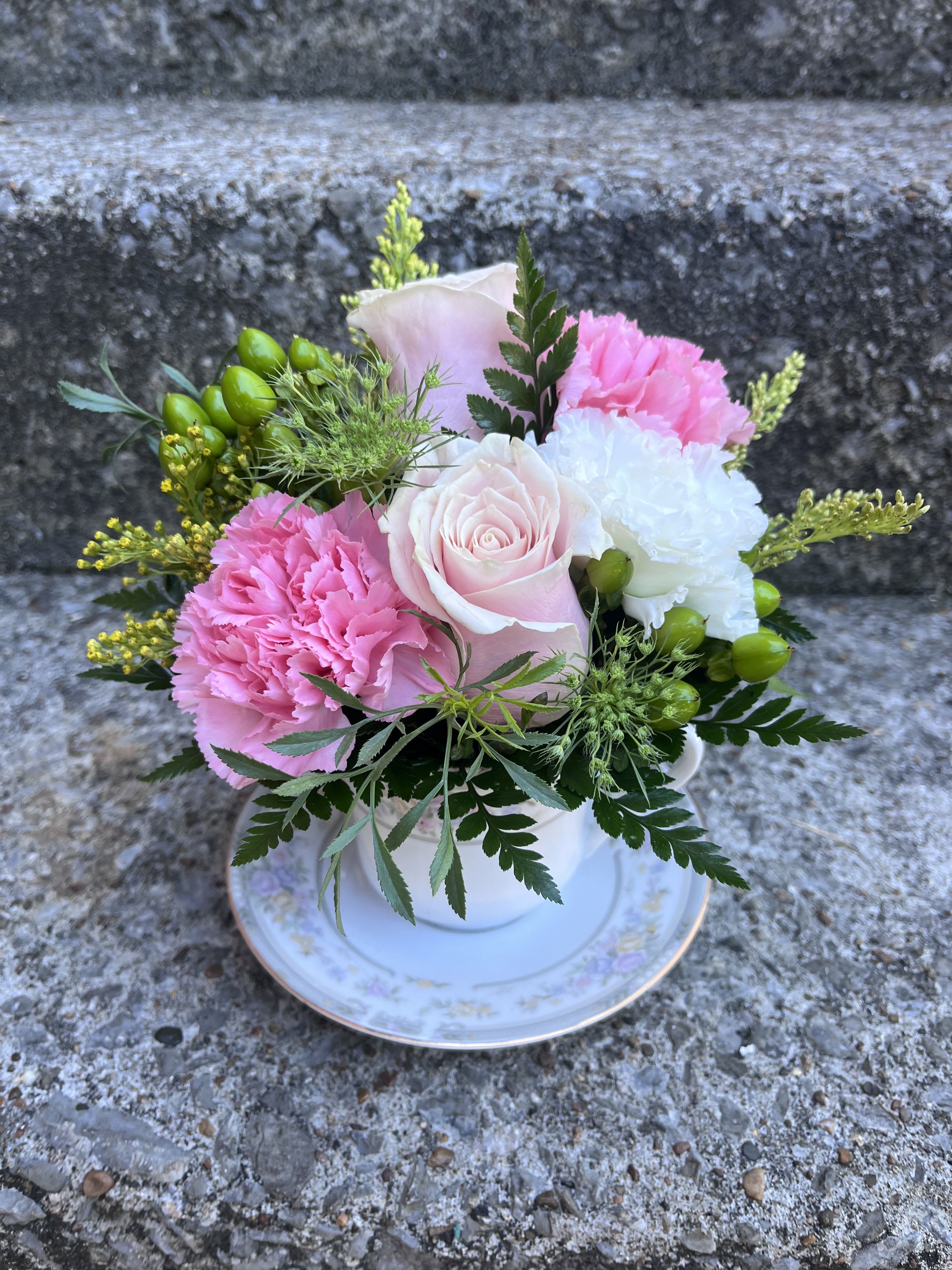 Pink Lemonade Tea Cup  - This arrangement has roses, hypericum, solidago, queen Ann’s lace, carnations and greenery. 