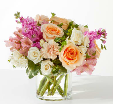 Paradise Bouquet - Paradise Bouquet transports you to tranquility with lush Peach Roses, delicate Pink Alstroemeria, and airy Bupleurum, all softly accented by variegated foliage.  Housed in a clean-lined glass cylinder, this serene arrangement is perfect for anniversaries, spa gifts, or creating an instant oasis of calm.  Approximately 10"H x 14"W. Order now for fresh flower delivery!