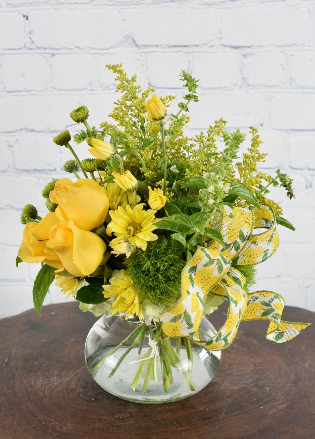 A Little Sunshine - A beautiful compact design filled with yellow roses, yellow daisies, green button mums, and solidago. A cheery yellow arrangement perfect to brighten someone's day!