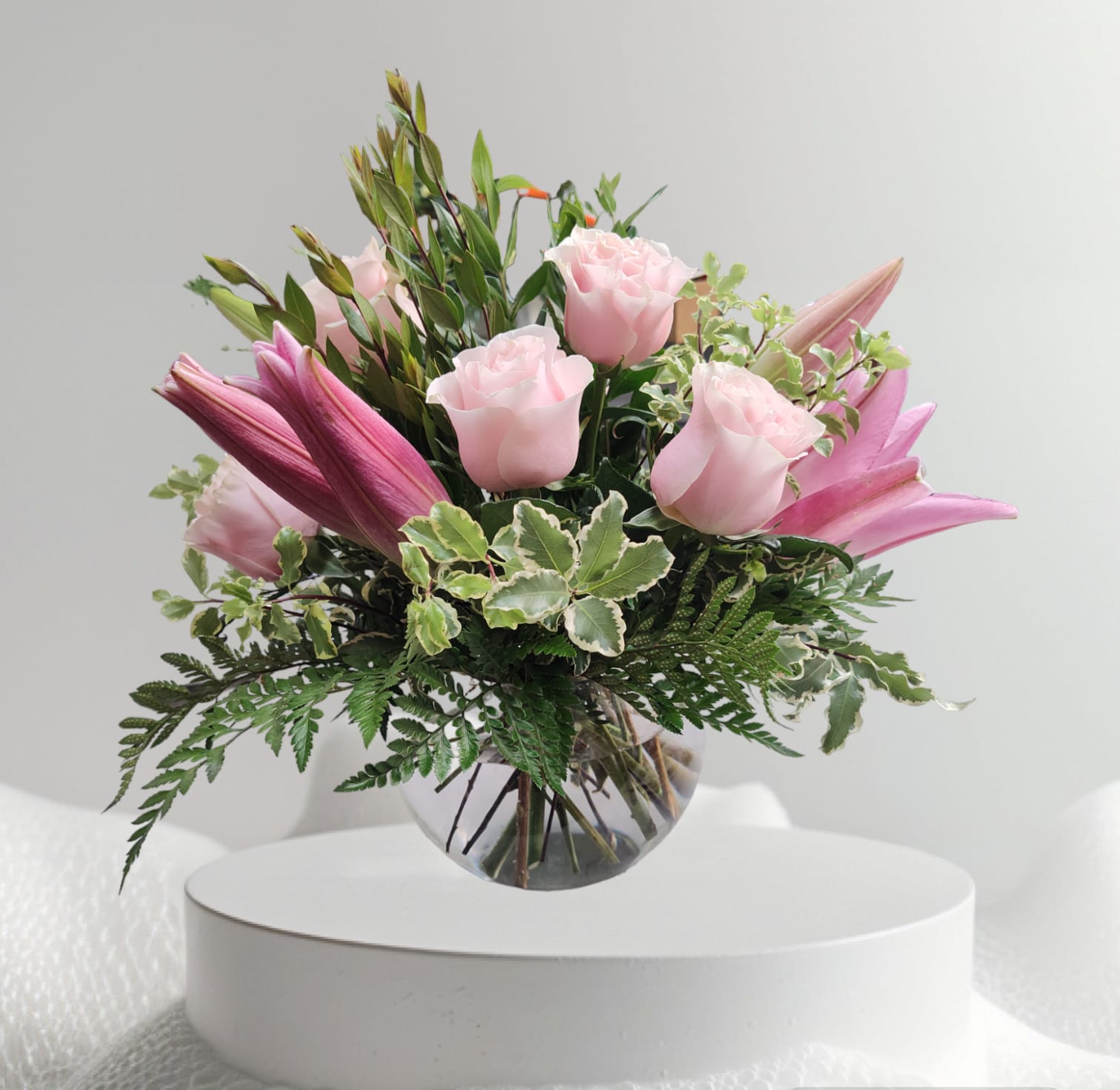 PINK BUBBLE BEAUTY - DELICATE SHADES OF PINK ORIENTAL LILIES AND PINK MONDIAL ROSES, IN A BUBBLE BOWL