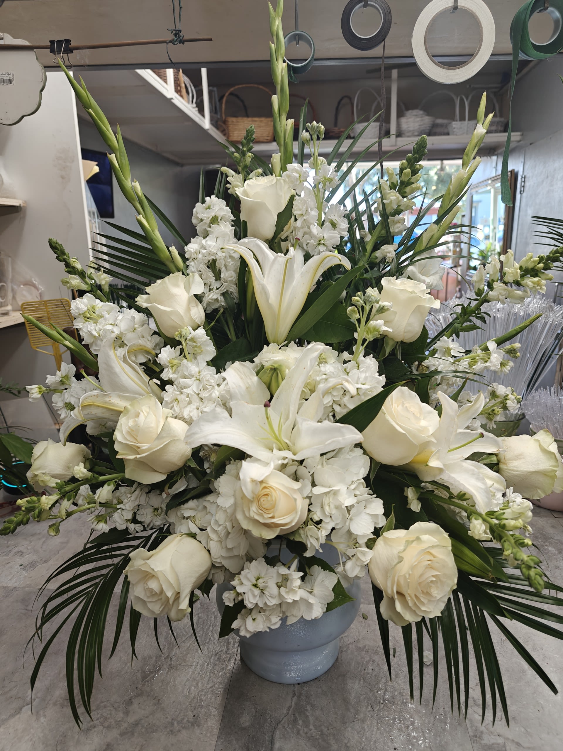 SERENITY BLOOMS - A SYMPATHY ARRANGEMET OF MIXED WHITE FLOWERS TO REMEMBER YOUR LOVED ONES.