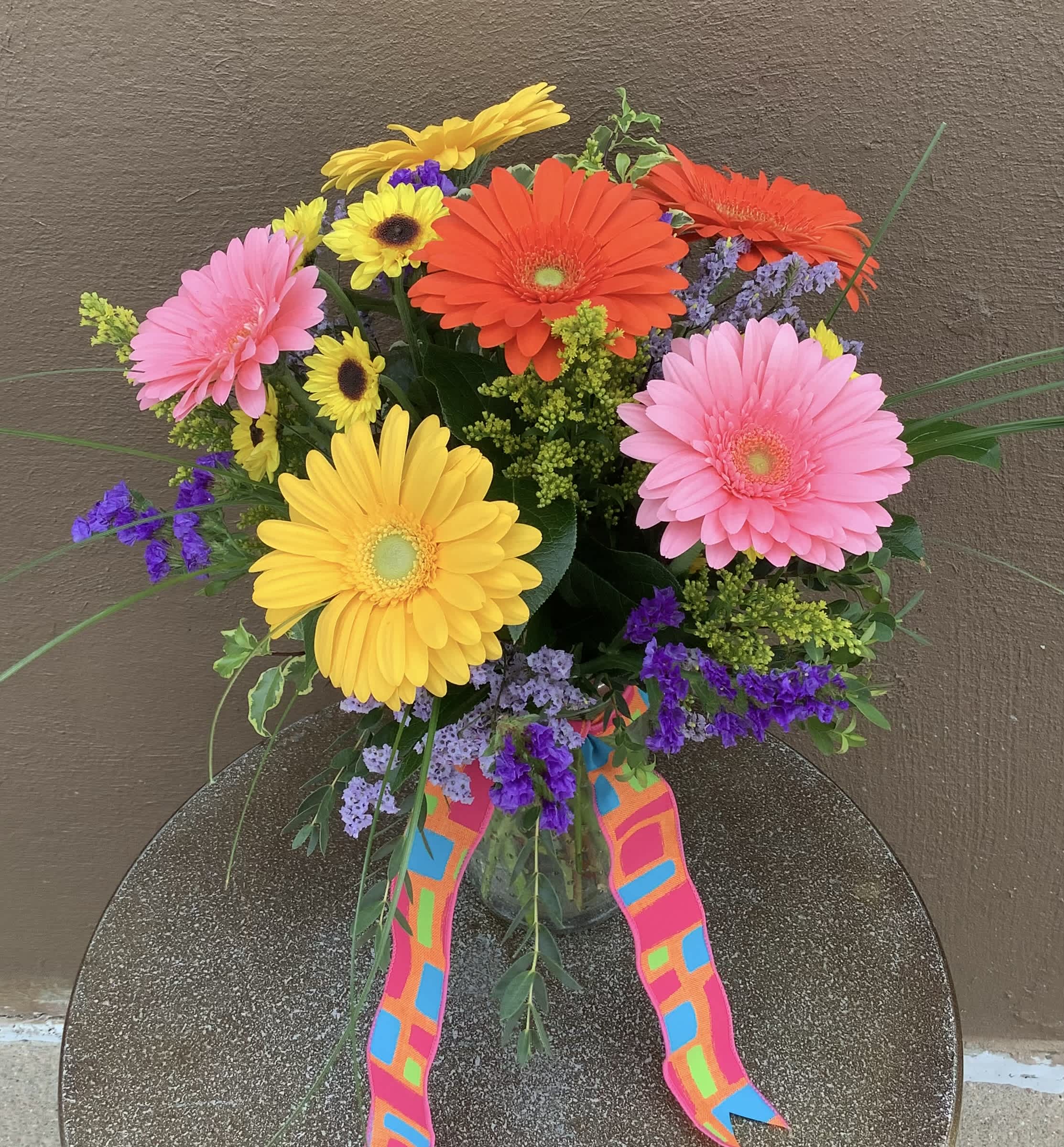 Everything’s Coming Up Daisies - This collection of vibrant gerbera daisies and Viking mums is a definite spirit-lifter!