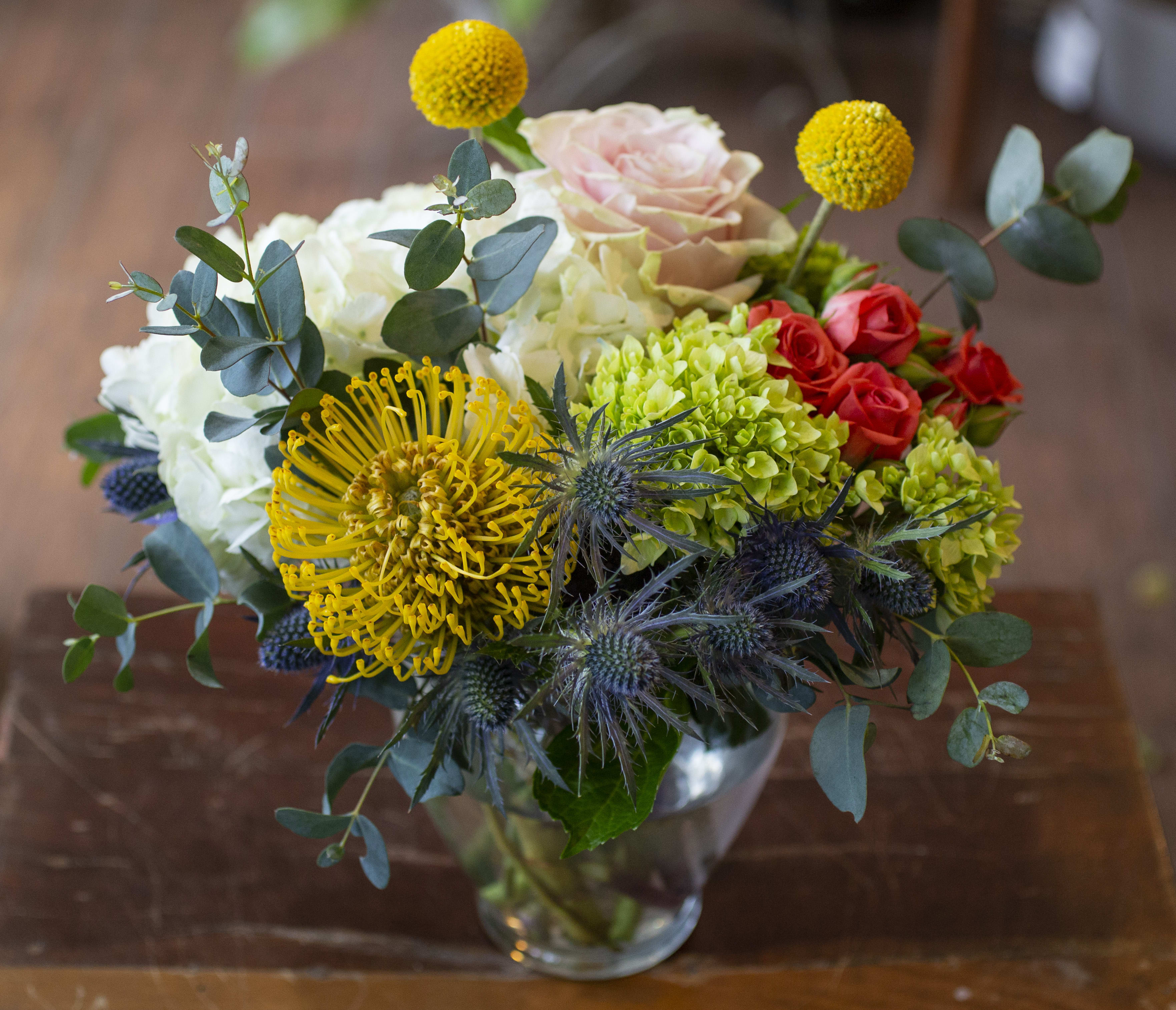 Sansa - Array of textures and colors arranged in a glass vase. 