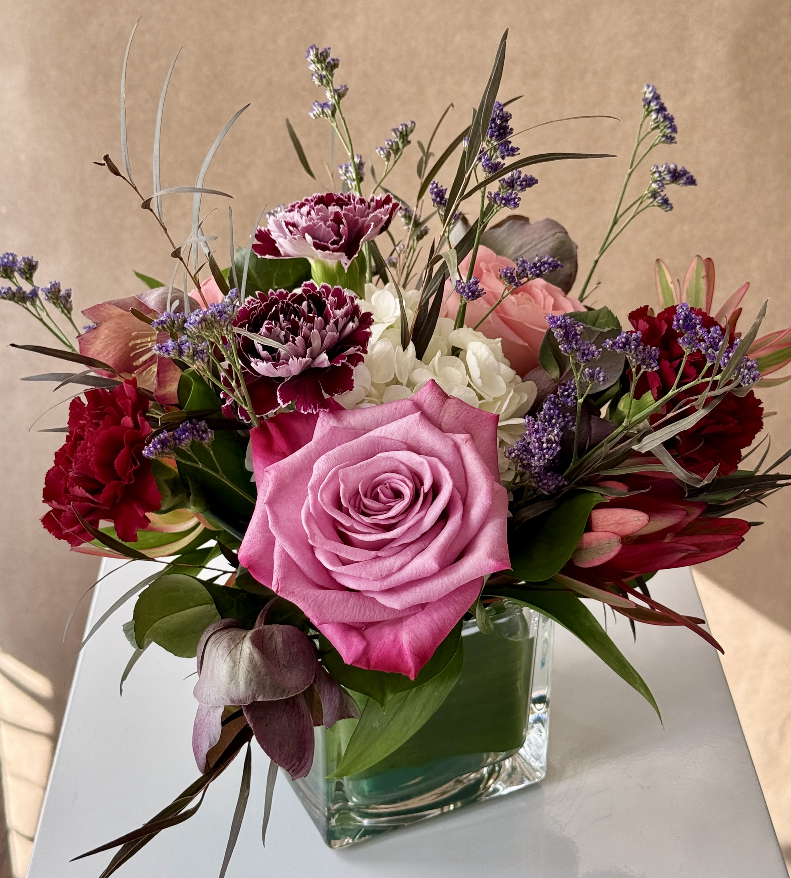 Mabel - A delightful and fluffy mini arranged in a clear glass vase.