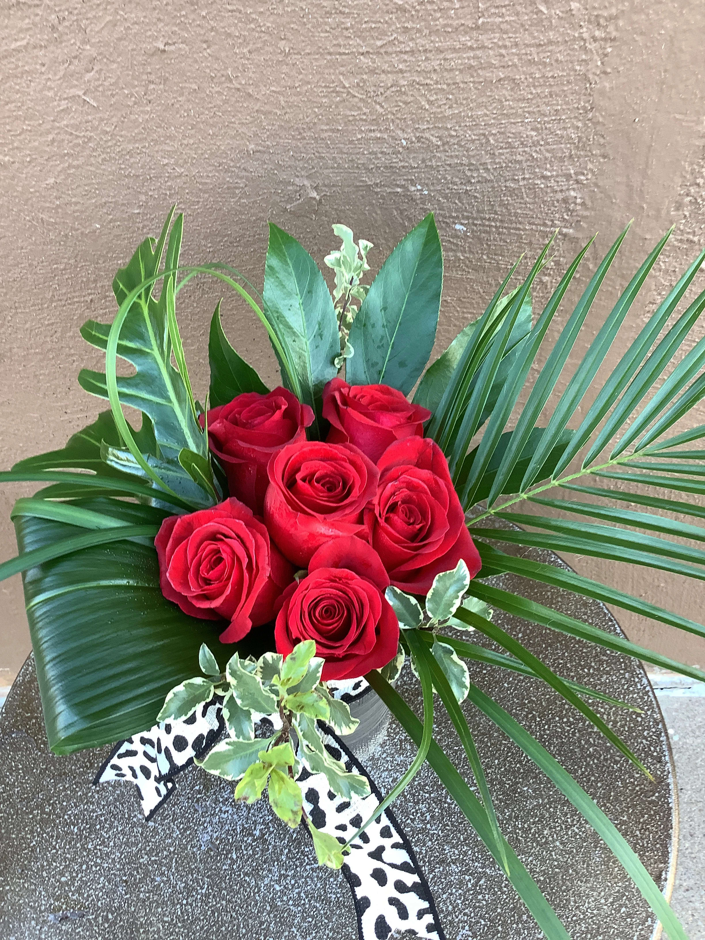 Wild Thing - Six beautiful red roses with tropical forges and a black cheetah ribbon