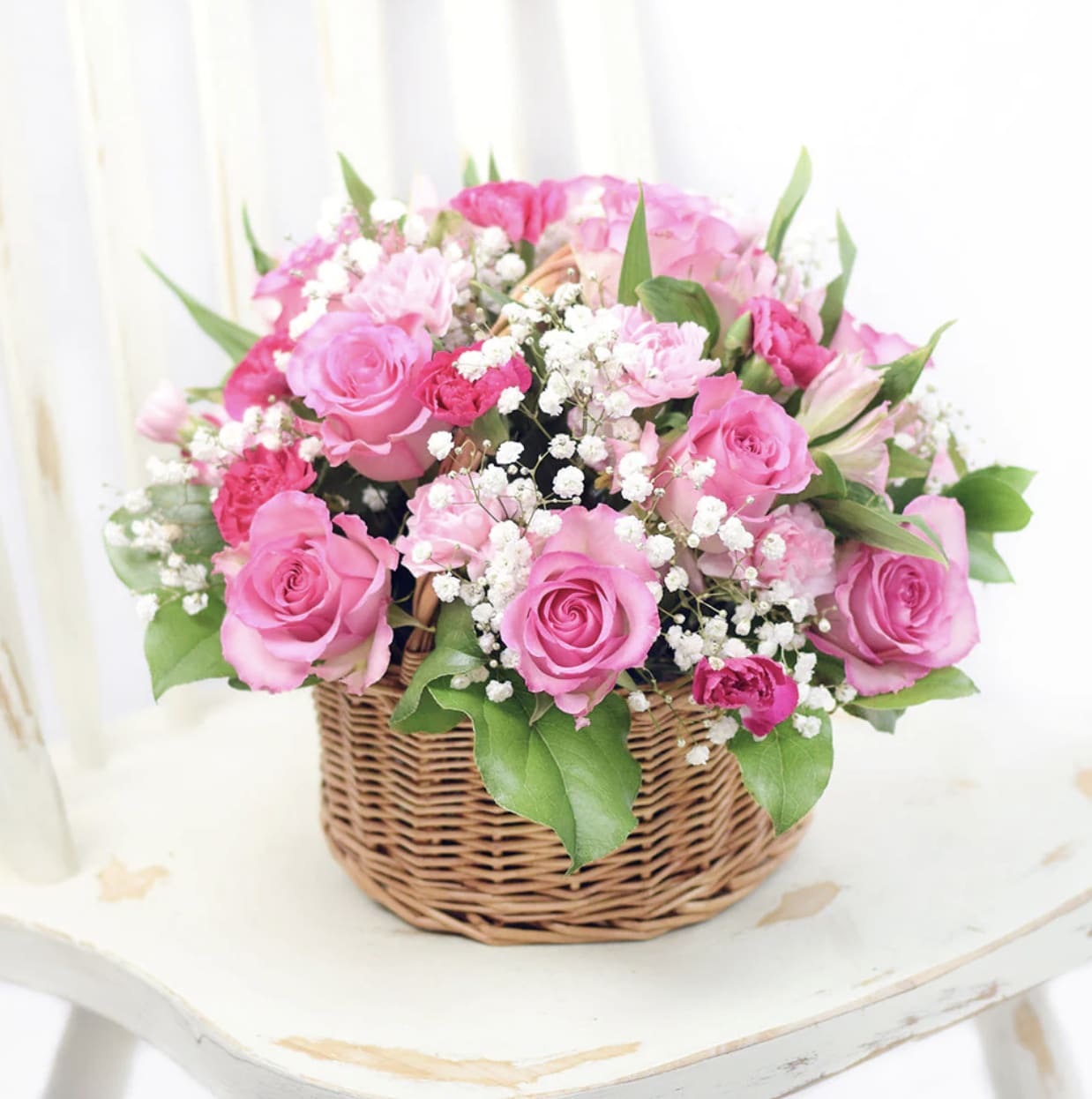 Pink Angel Basket  - Pink Angel Basket Composed of beautiful spring flowers and pink roses. This flower basket makes for a great gift for new baby born. This basket is a charming floral arrangement full of romantic energy and softness, ideal for welcoming a new baby girl, celebrating love, or simply brightening a special day. This arrangement feels light and joyful-a blend of gentle blooms and bright greens that create a natural, garden-fresh look. The roses in soft and medium pink tones symbolize affection, sweetness, and admiration, while the white flowers adds a cloud-like tenderness. 